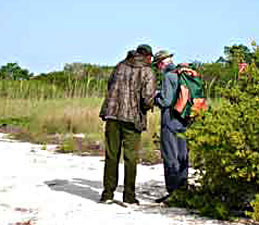 Rick and Tony conferring on Middle Cape. Note prairie and treed berm background.